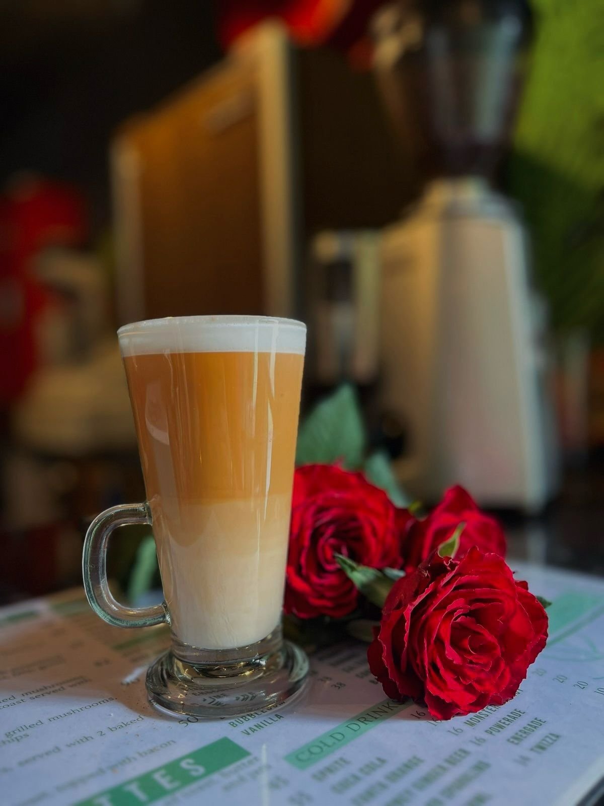 A cup of coffee served with a rose at The Green Door Café